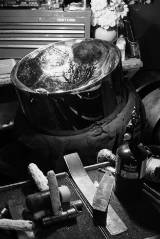 Black&White photo of workshop with tools for constructing a pan drum from a 55-gallon barrel